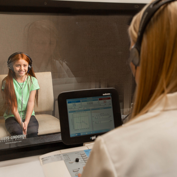 A hearing doctor in Wausau conducting a hearing test.