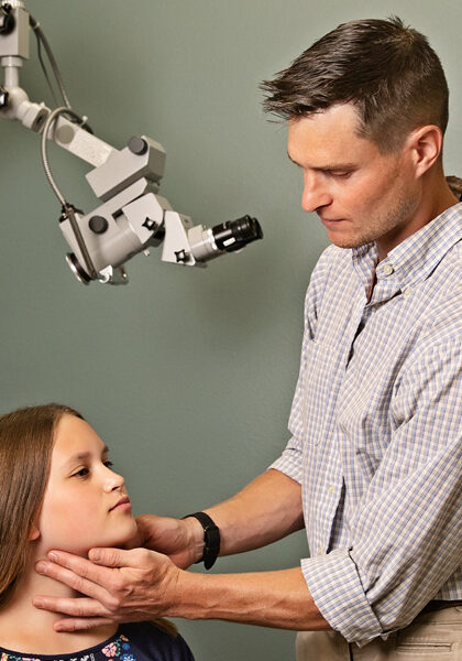 A doctor checking a child’s throat at an ENT clinic in Rhinelander.