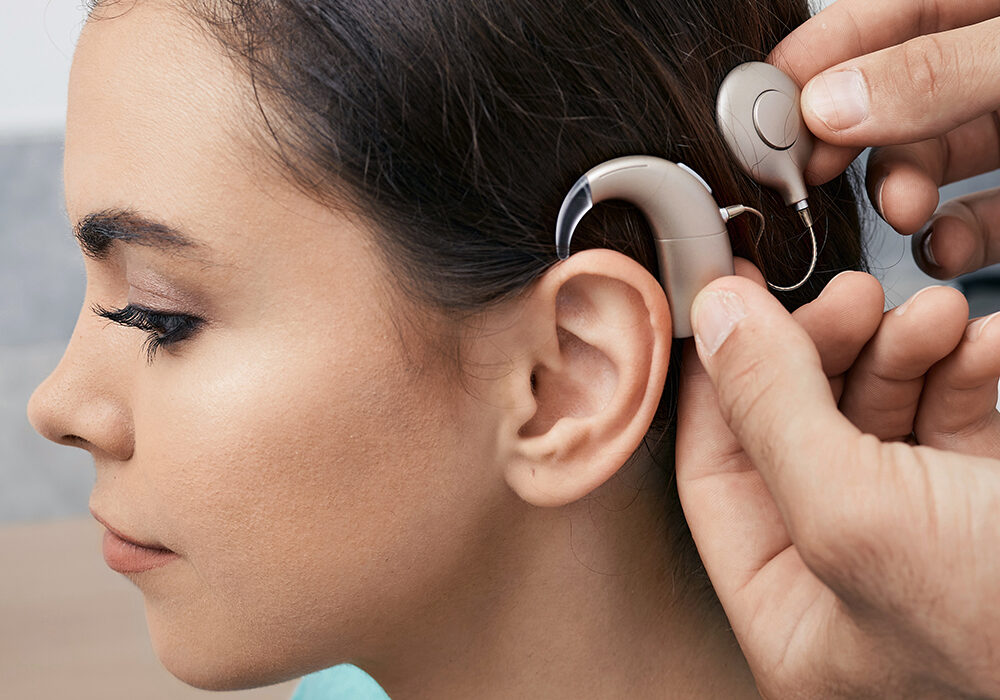 Audiologist in Wausau installing a cochlear implant.