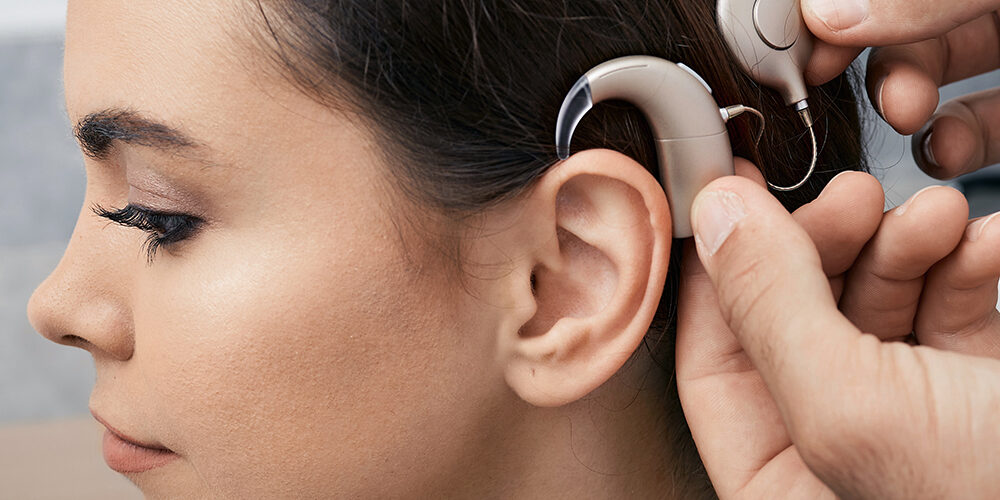 Audiologist in Wausau installing a cochlear implant.